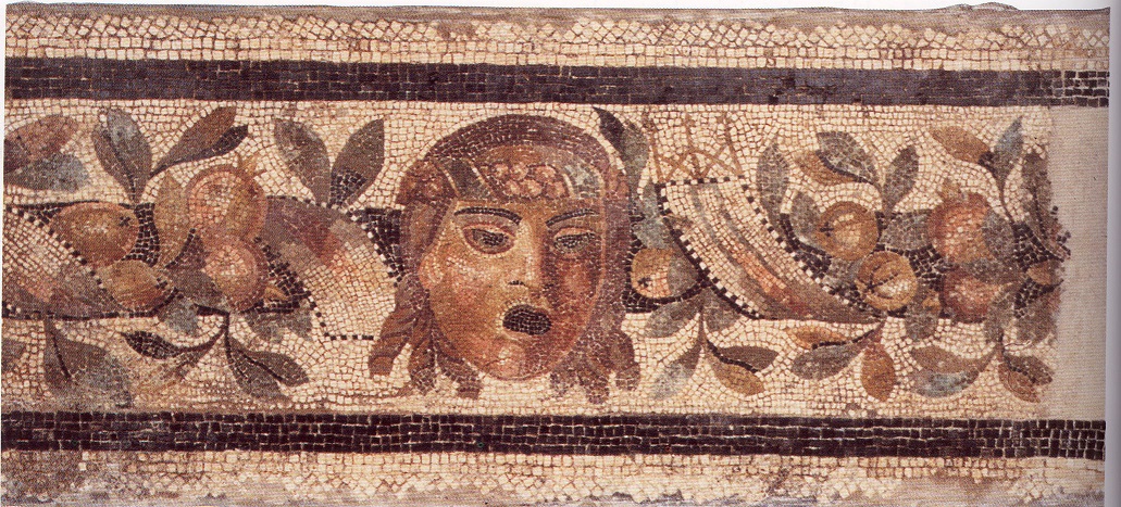 Fascia musiva con maschera di Dioniso fra festoni vegetali.
Mosaic band with a mask of Dionysus among vegetal festoons.
